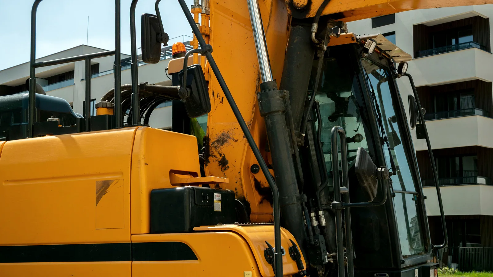 Excavator hydraulic arm and cylinder detail for machine parts sourcing